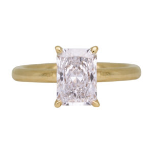 yellow gold under halo engagement ring centered with a rectangular radiant diamond