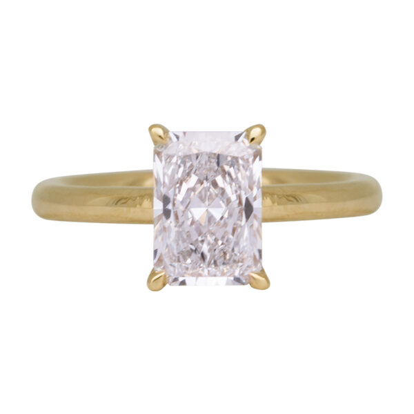 yellow gold under halo engagement ring centered with a rectangular radiant diamond