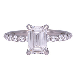 white gold engagement ring centered with an emerald cut diamond and round diamonds in the band