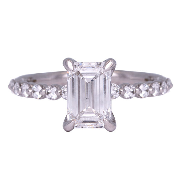 white gold engagement ring centered with an emerald cut diamond and round diamonds in the band
