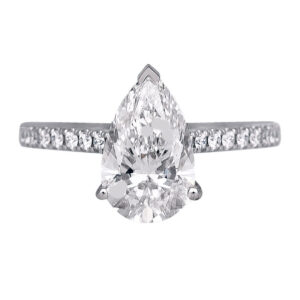 white gold engagement ring with a pear diamond and round diamonds in the band
