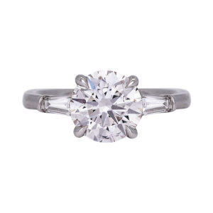 white gold 3-stone engagement ring centered with a round brilliant diamond flanked by 2 horizontal baguette diamonds