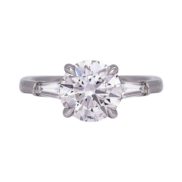 white gold 3-stone engagement ring centered with a round brilliant diamond flanked by 2 horizontal baguette diamonds