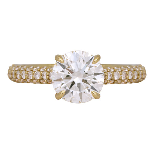 yellow gold engagement ring set with a round brilliant diamond and round small, brilliant diamonds in the band