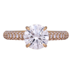 yellow gold engagement ring set with a round brilliant diamond, under halo, and diamonds in the band