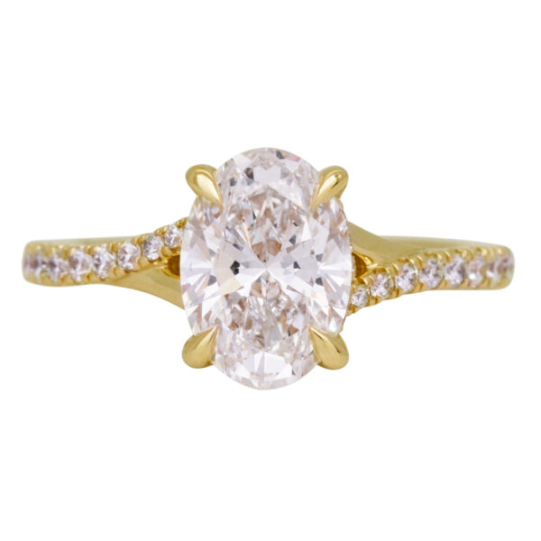 yellow gold under halo engagement ring centered with an oval diamond and set with diamonds in the band