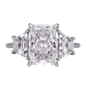 white gold 3-stone engagement ring centered with large emerald cut diamond flanked by two trapezoid diamonds