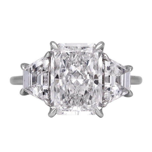 white gold 3-stone engagement ring centered with large emerald cut diamond flanked by two trapezoid diamonds