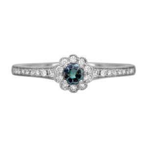 white gold ring centered with a small round alexandrite surrounded by a round diamond halo and diamonds in the band