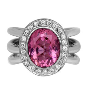 white gold halo ring set with an oval pink tourmaline surrounded by a diamond halo