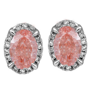 white gold earrings set with oval pink diamonds surrounded by white round diamond haloes