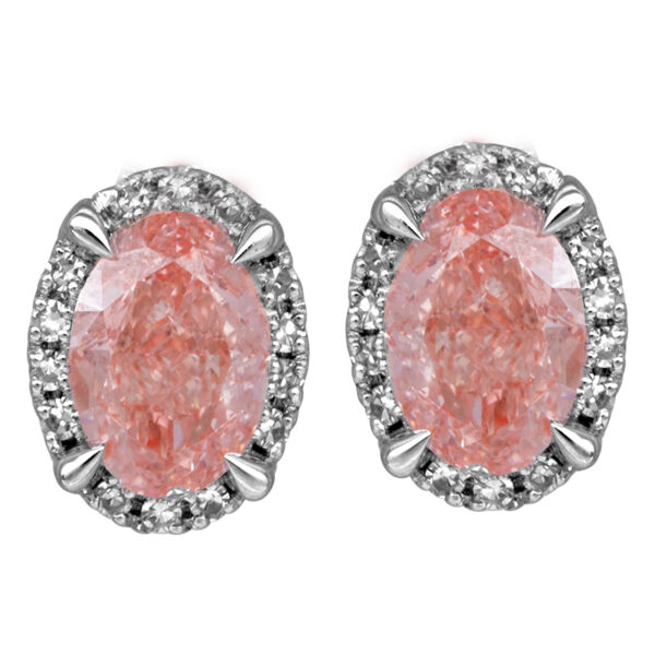 white gold earrings set with oval pink diamonds surrounded by white round diamond haloes