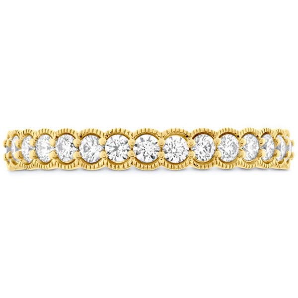 yellow gold band set with round brilliant diamonds and milgrain texture