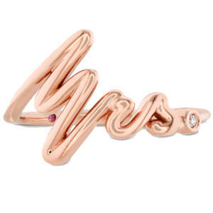rose gold ring with "Mrs." written in cursive with a small diamond as the period.