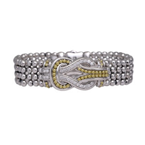 statement bracelet of sterling and yellow gold with a knot motif, set with small round diamonds