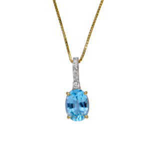 yellow gold pendant set with an oval blue topaz & small round brilliant diamonds