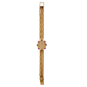 yellow gold fashion watch with a ruby and diamond bezel and 5-row mesh bracelet