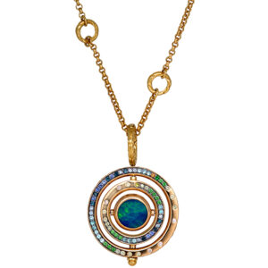 yellow gold John Hardy pendant in concentric circles set with blue and green stones