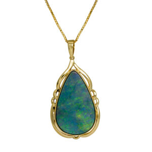 yellow gold pendant set with a blue and green pear shaped cabochon opal