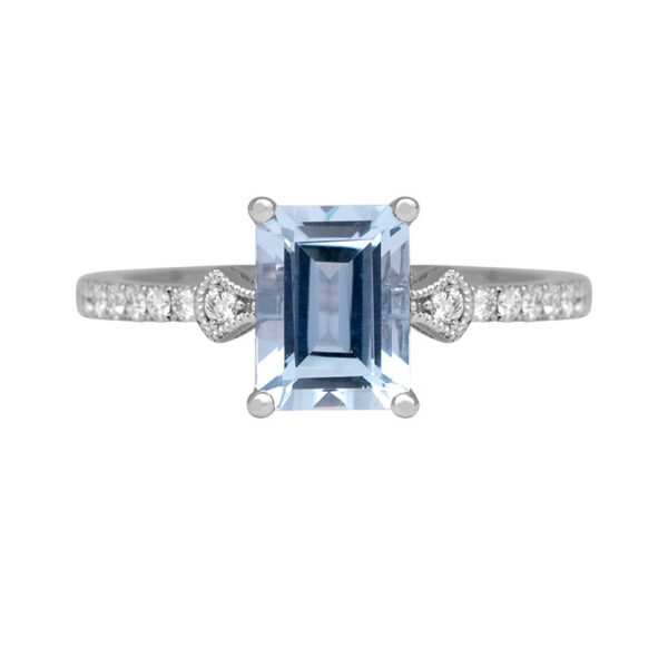 white gold ring centered with an emerald aquamarine and round diamonds in the band