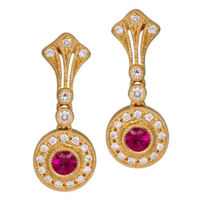 yellow gold halo drop earrings set with round rubies surrounded by round brilliant diamonds
