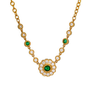 yellow gold necklace set with round brilliant emeralds surrounded by round brilliant diamonds