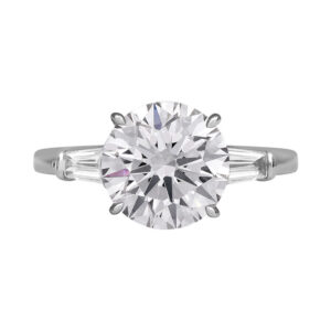 white gold 3-stone engagement ring centered with a round brilliant diamond and flanked by two tapered baguette diamonds