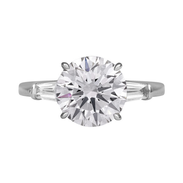 white gold 3-stone engagement ring centered with a round brilliant diamond and flanked by two tapered baguette diamonds