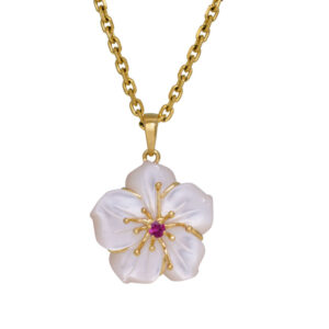 yellow gold pendant with a carved mother-of-pearl flower and set with a small round brilliant ruby