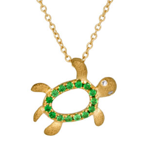 yellow gold turtle pendant set with round tsavorite garnets and a round brilliant diamond
