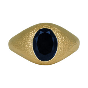 yellow gold tapered ring with texture and a 3 carat oval blue sapphire