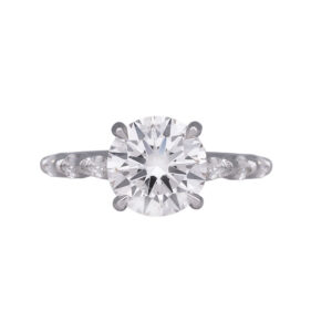 white gold engagement ring centered with a round brilliant diamond and round and marquise diamonds in the band