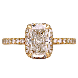yellow gold halo engagement ring centered with a radiant diamonds surrounded by round diamonds in the halo & band