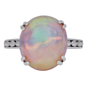 white gold ring set with an oval opal and round diamonds in the band