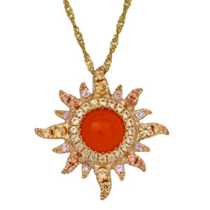yellow gold sunburst pendant centered with a Mexican fire opal surrounded by round pink sapphires in the sun rays