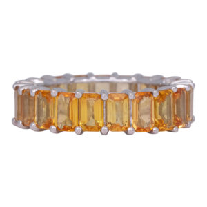 white gold eternity band set with emerald cut yellow sapphire
