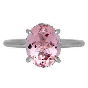 white gold under-halo ring centered with an oval pink morganite with a round diamond under-halo