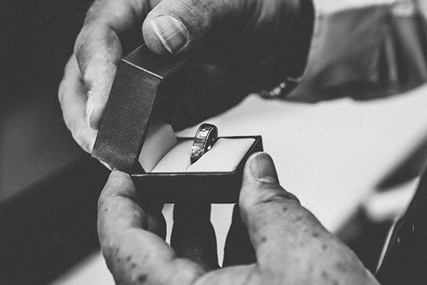 Person holding silver ring black and white photo