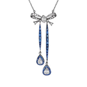 antique platinum bow necklace set with square sapphires and pear, marquise, and old mine cut diamonds