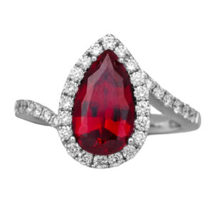 white gold ring centered with a pear cut ruby surrounded by round diamonds in the halo and band
