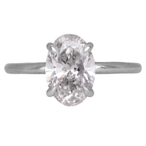 white gold solitaire engagement ring centered with an oval diamond