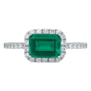 white gold halo ring centered with a horizontal emerald cut emerald surrounded by round diamonds in the halo and band