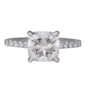 white gold engagement ring centered with a cushion cut diamond & round diamonds in the under-halo & band
