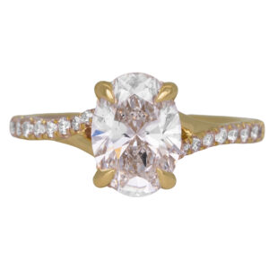 yellow gold under-halo engagement ring set with an oval diamond with round brilliant diamonds in the band and under-halo