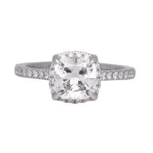 white gold halo engagement ring centered with a cushion diamond surrounded by round brilliant diamonds