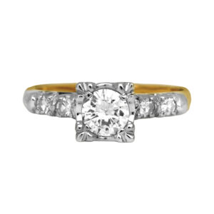 Vintage 14k yellow & white gold engagement ring set with a 0.50 carat round brilliant earth-mined center diamond plus 0.12 carats of single-cut earth-mined diamonds in the band.