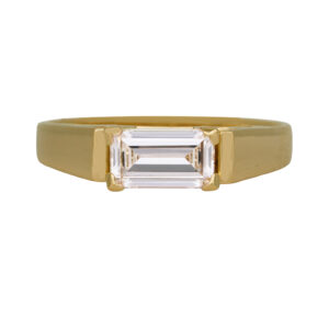yellow gold ring set with an east-west emerald cut diamond