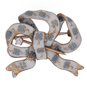 yellow gold brooch with white and blue enamel, depicting flowers. One small round brilliant diamond