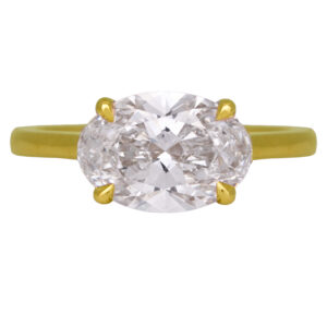 yellow gold solitaire engagement ring set with an east-west oval diamond