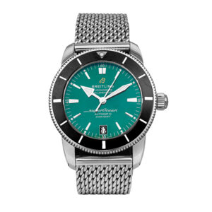 stainless steel watch with a green dial, black bezel, mesh bracelet